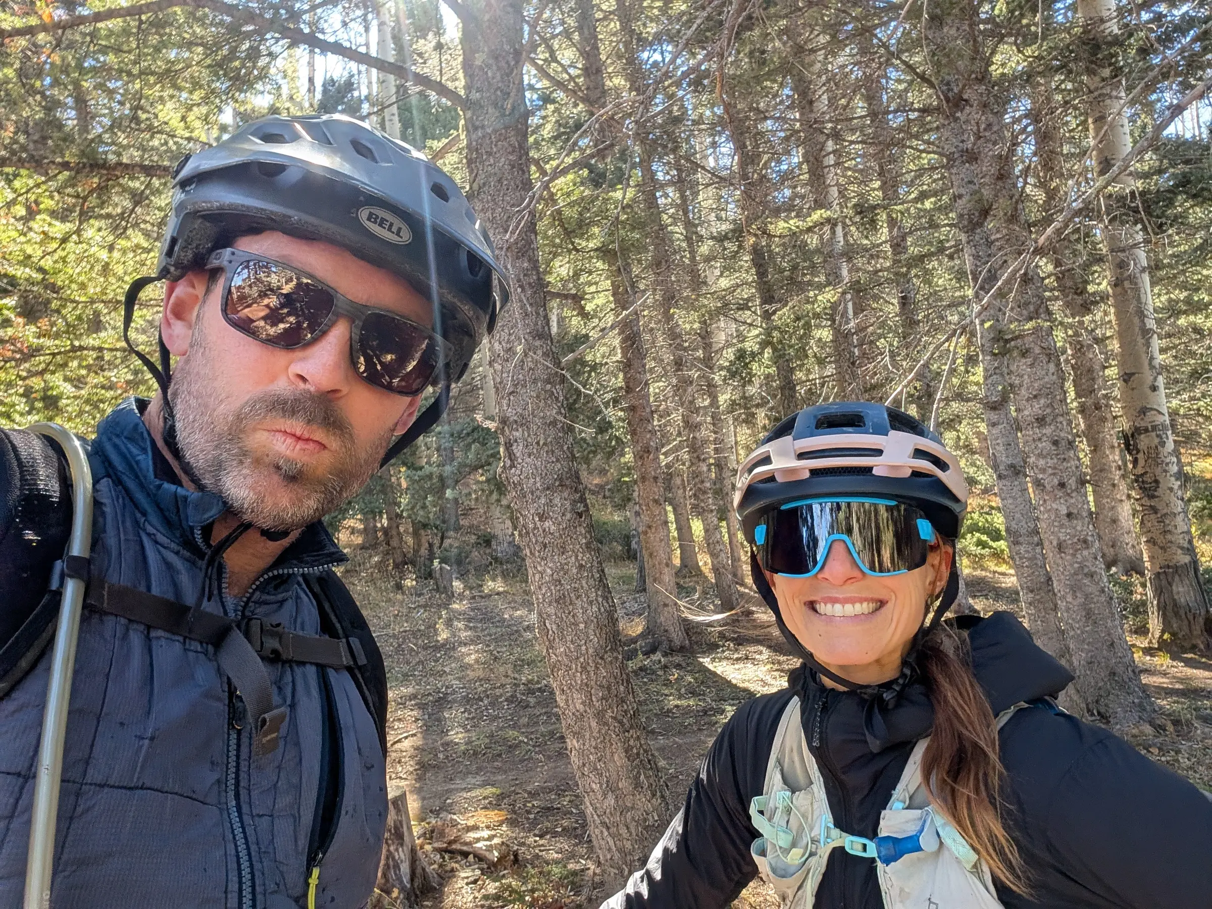 The two of us in bike helmets on a forest trail